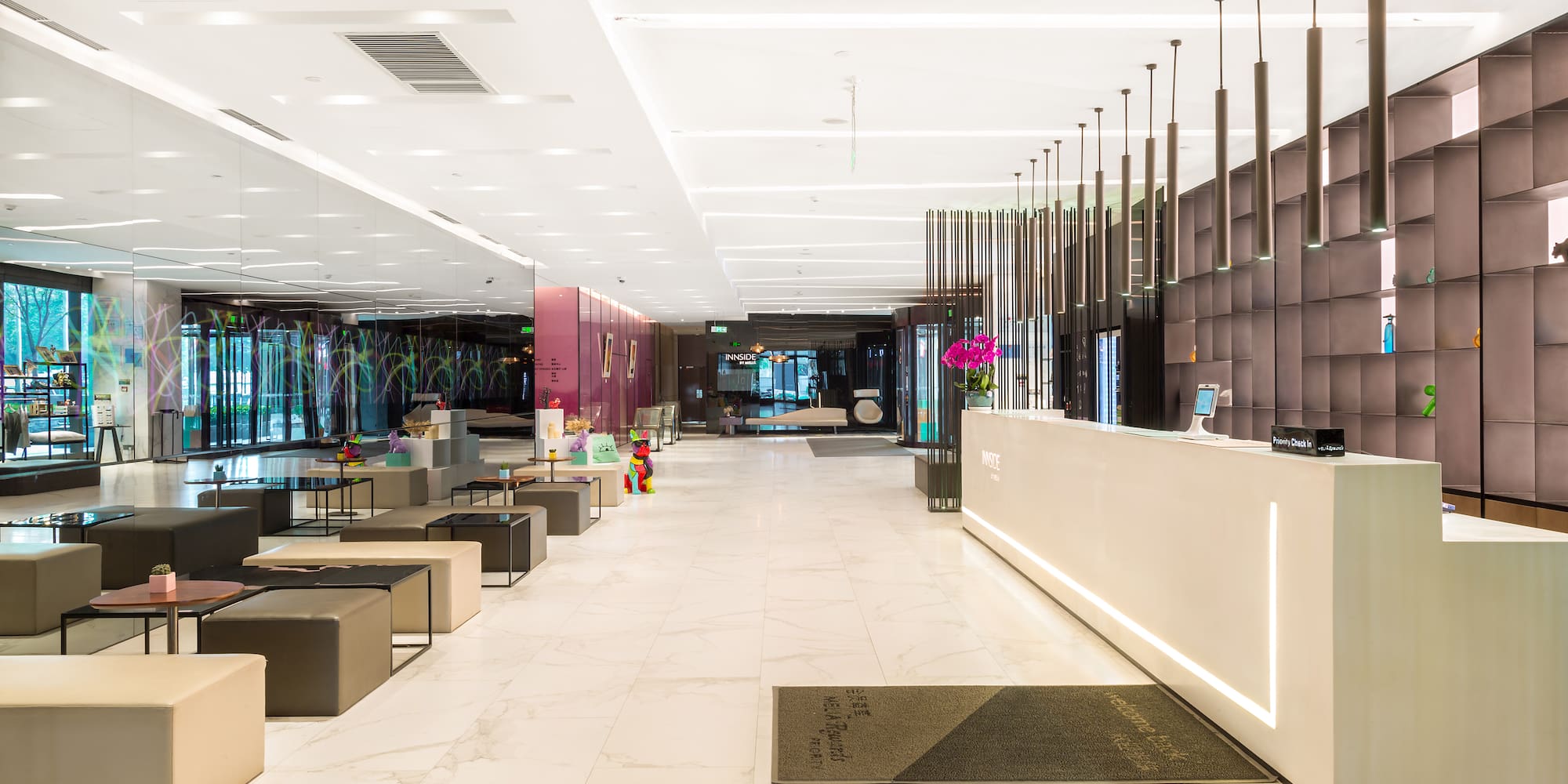 a lobby with a reception desk and chairs