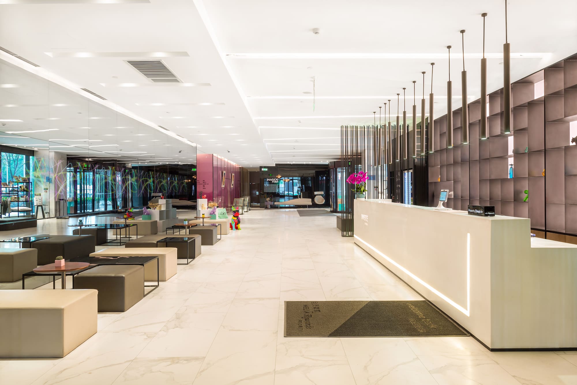 Innside by Meliá hotel lobby with sleek reception desk and lounge seating.