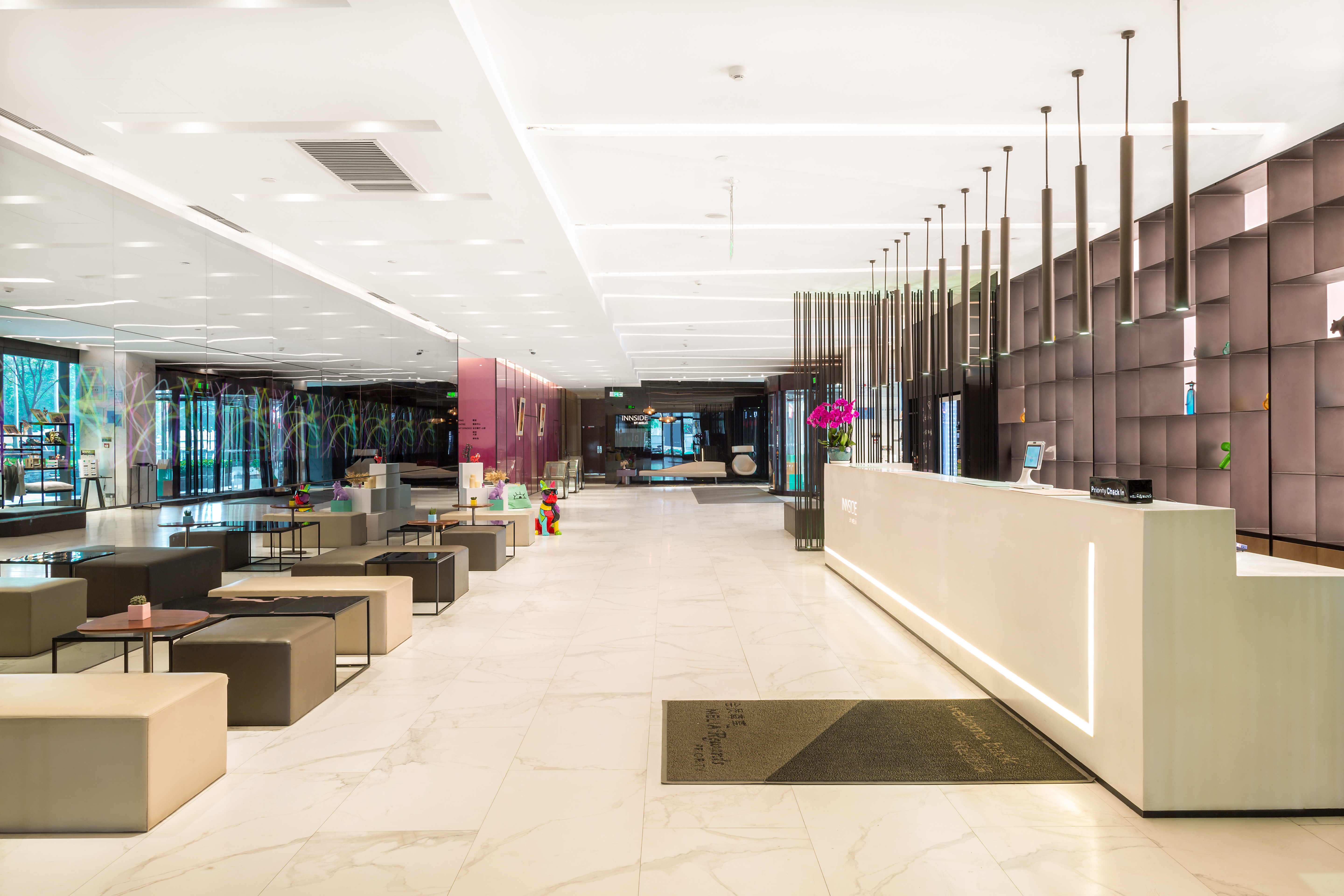 a lobby with a reception desk and chairs