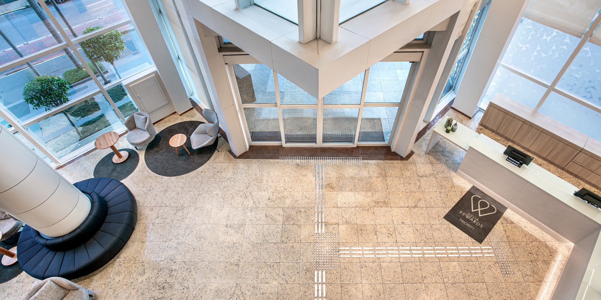 a large lobby with a large black round chair and a black table
