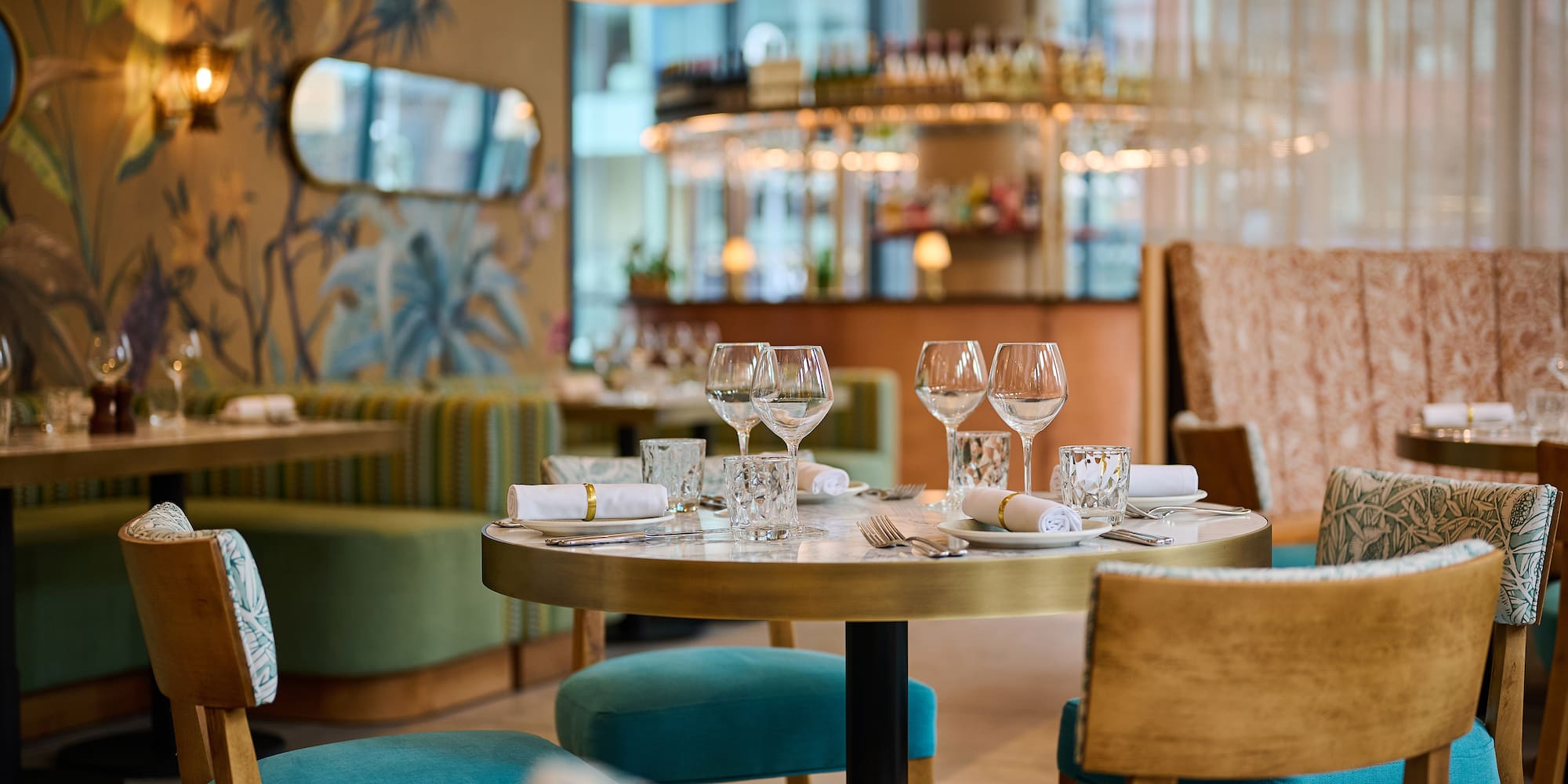 a table with glasses and napkins in a restaurant