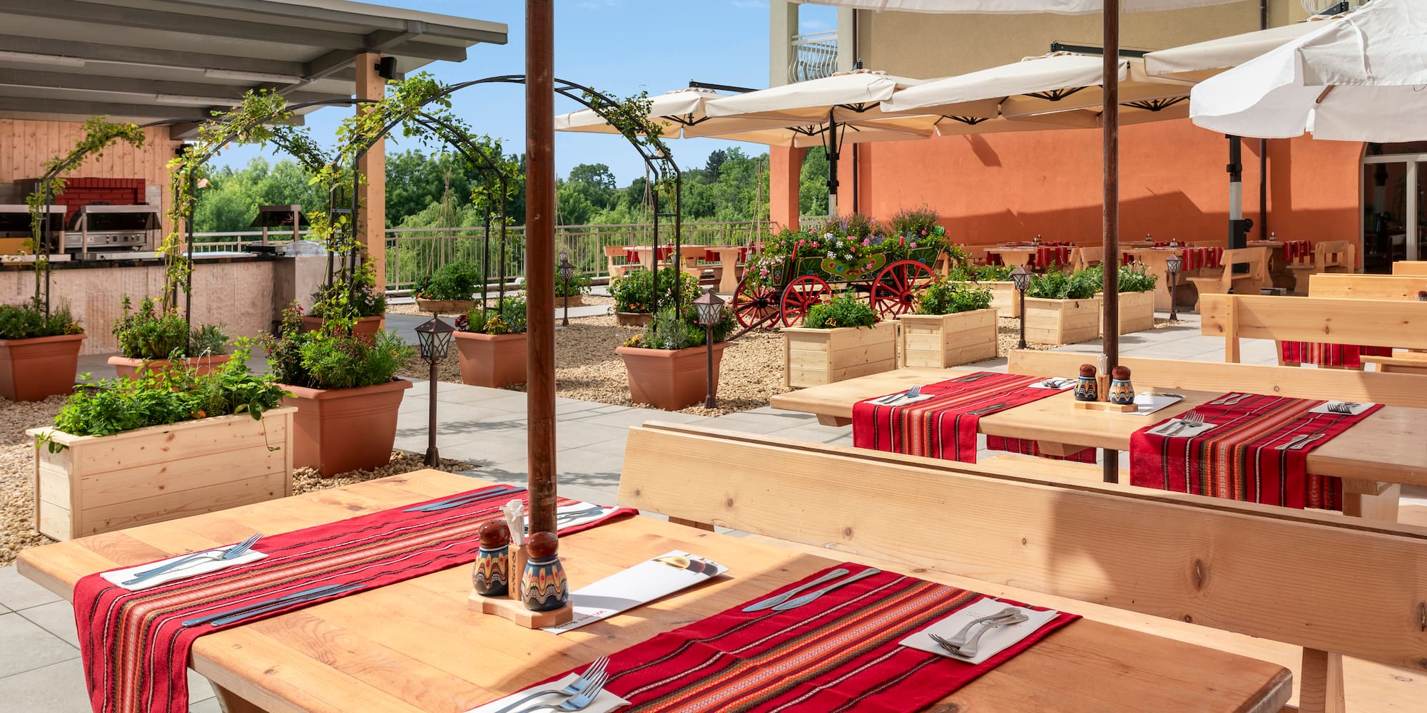 a table with red cloth and white umbrellas