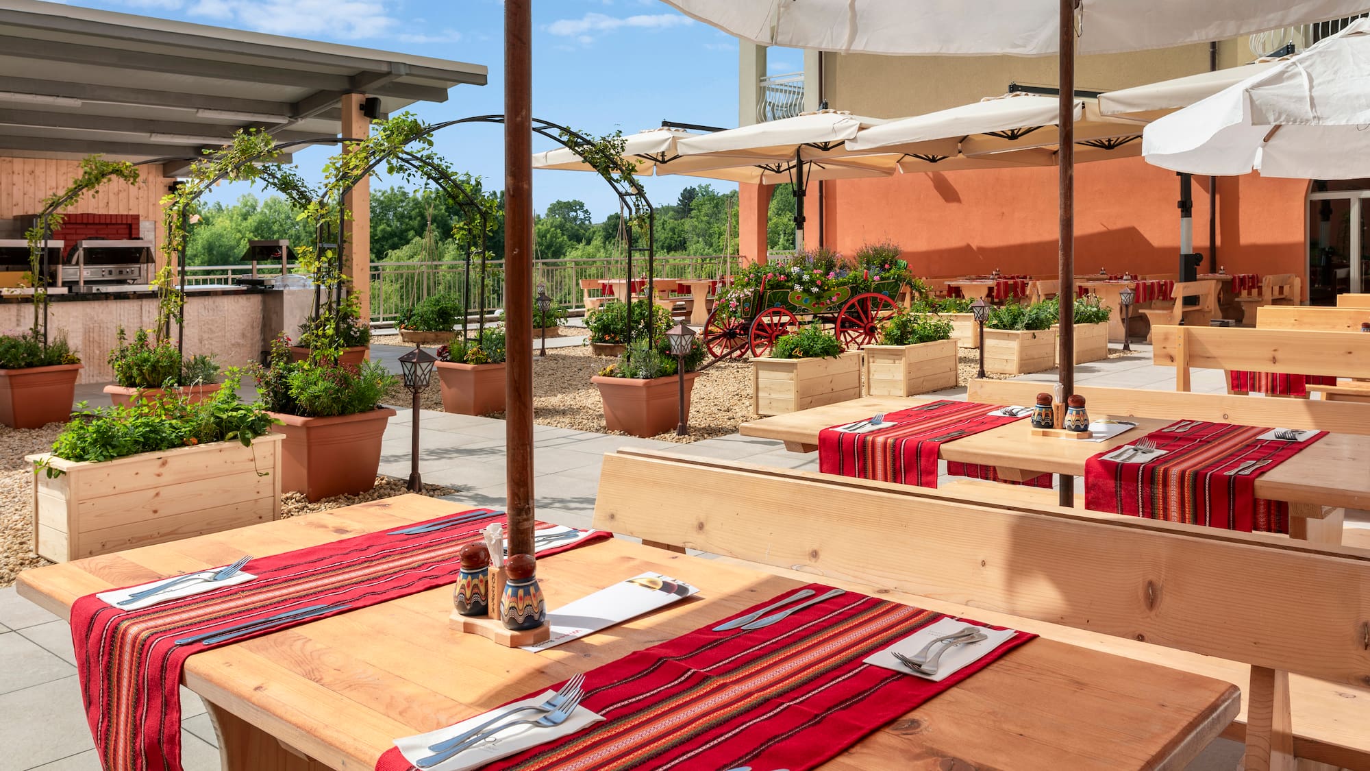 a table with red cloth and white umbrellas