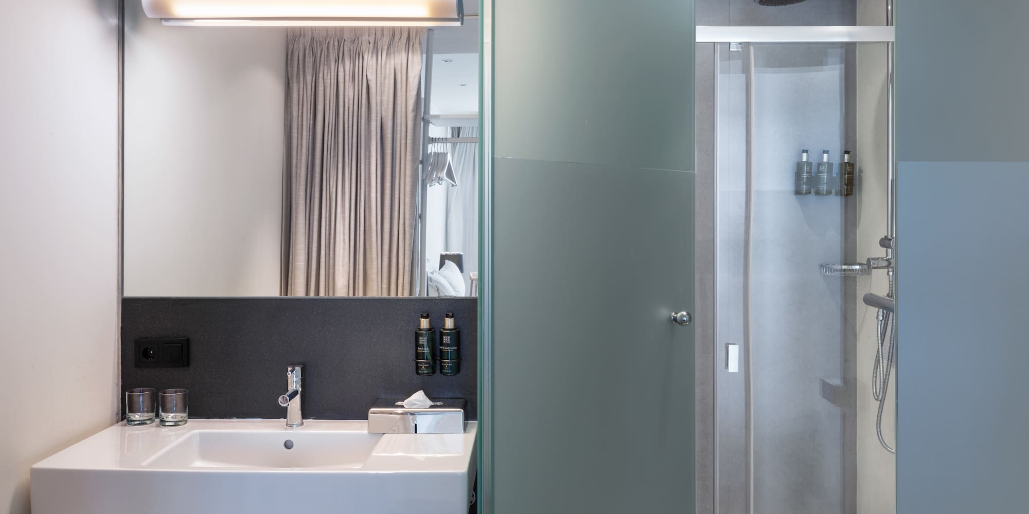 a bathroom with a shower and sink