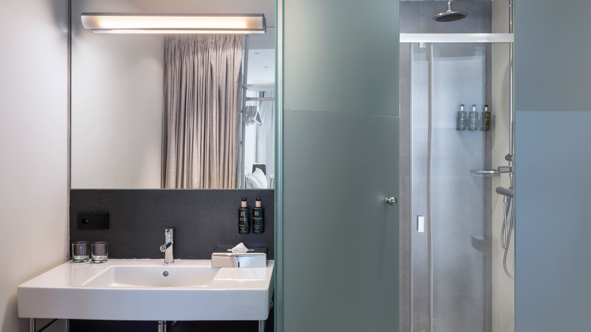 a bathroom with a shower and sink