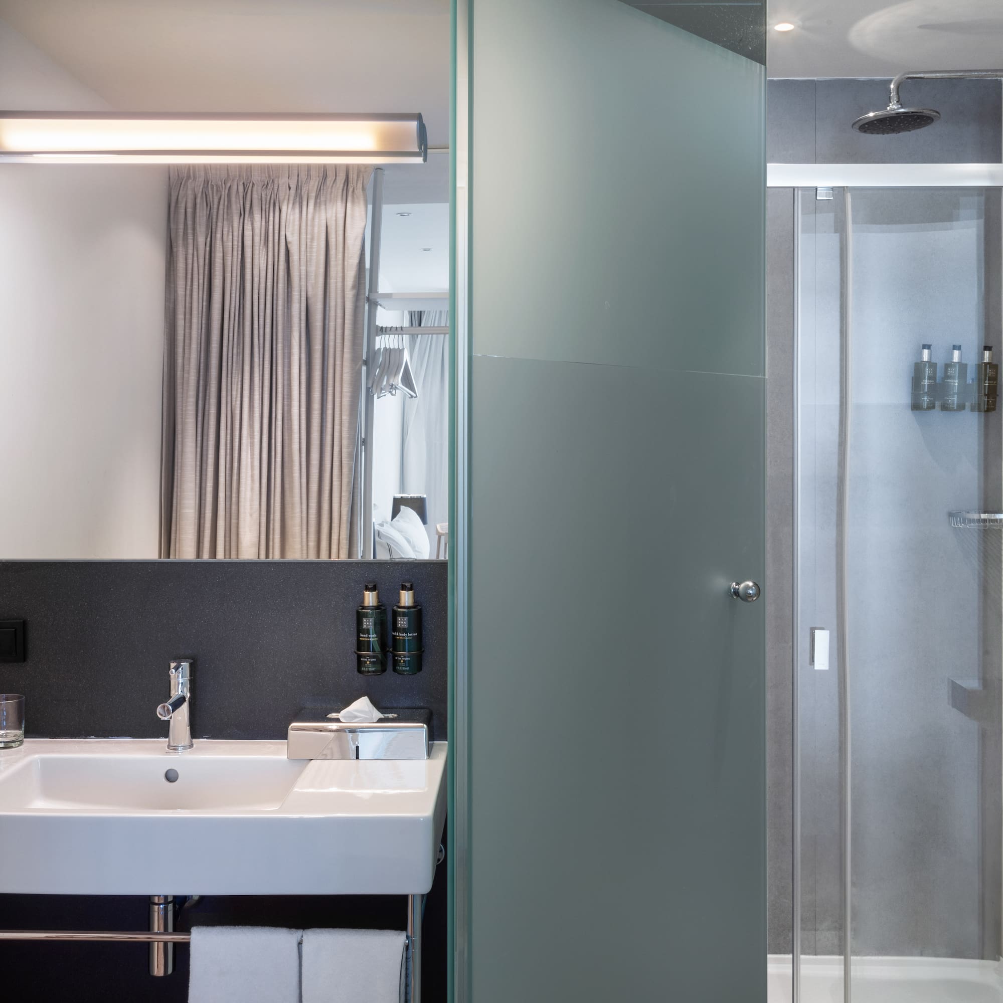 a bathroom with a shower and sink