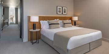 a bed with a wood headboard and a lamp