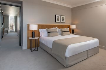 a bed with a wood headboard and a lamp
