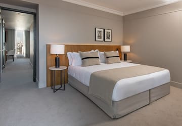 a bed with a wood headboard and a lamp
