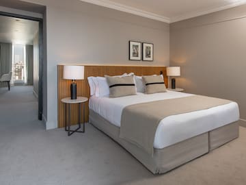 a bed with a wood headboard and a lamp