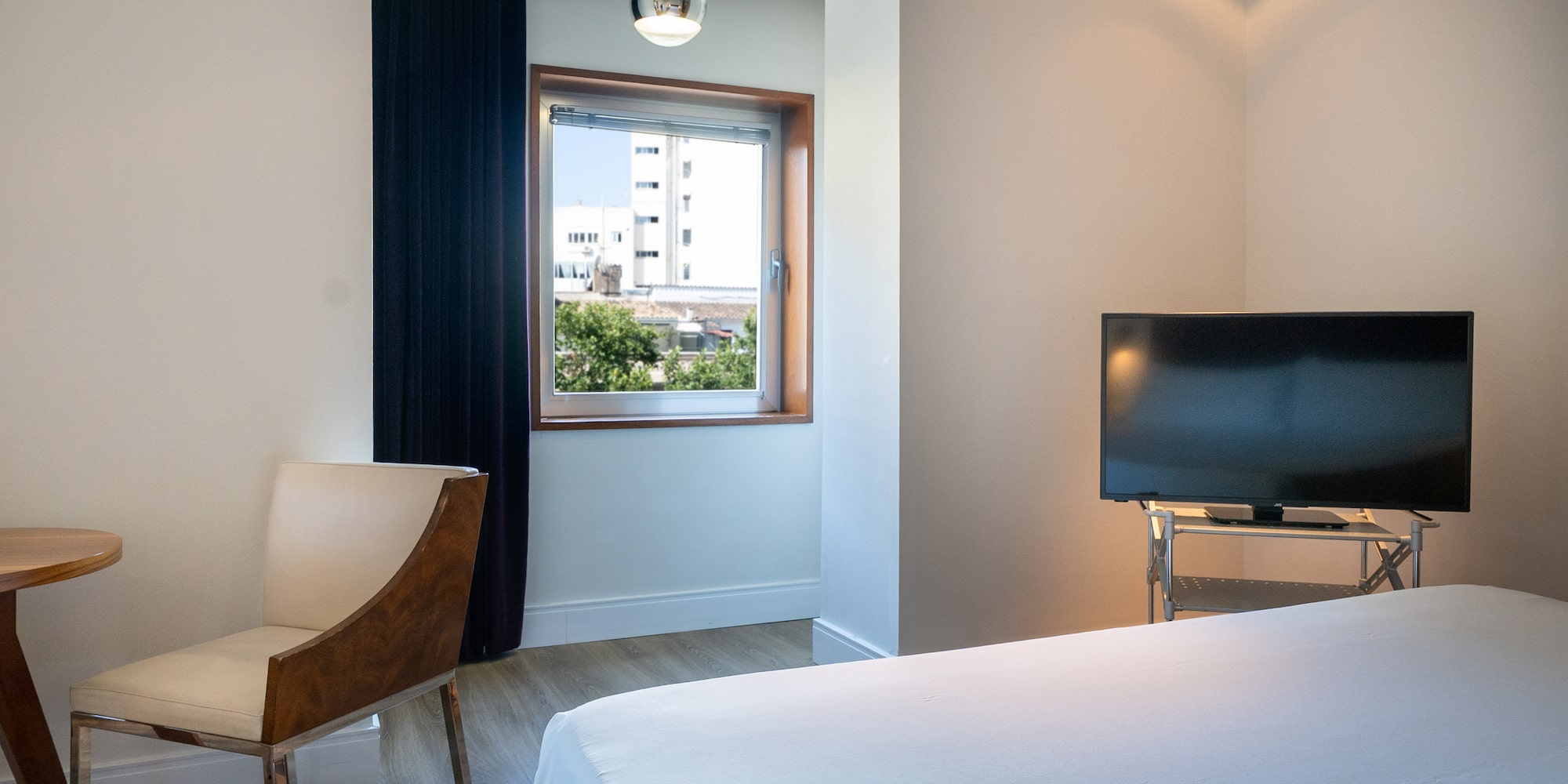 a room with a tv and a bed