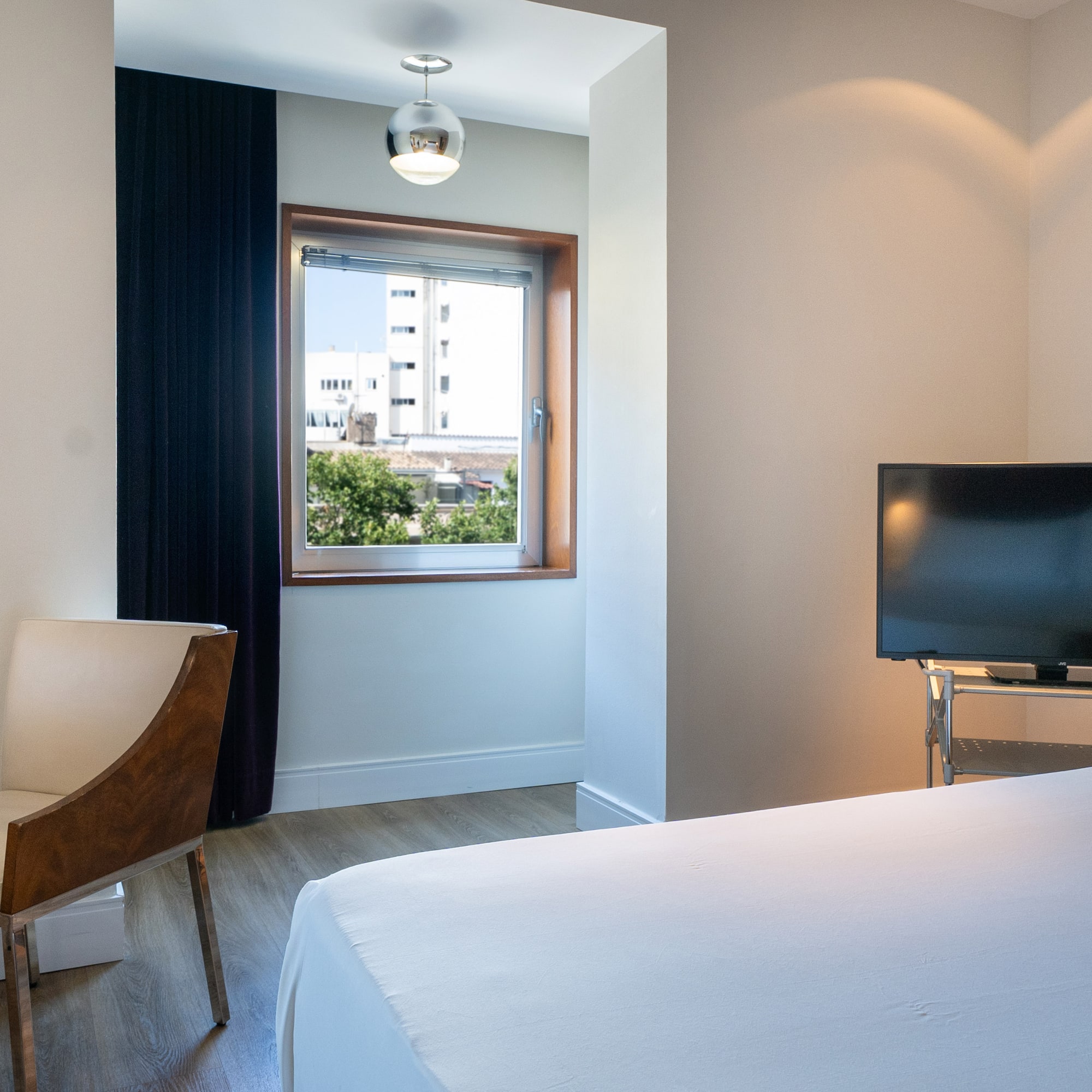 a room with a tv and a bed