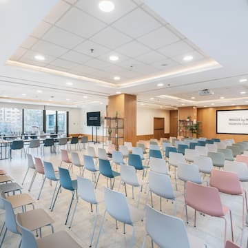 a room with many chairs and tables