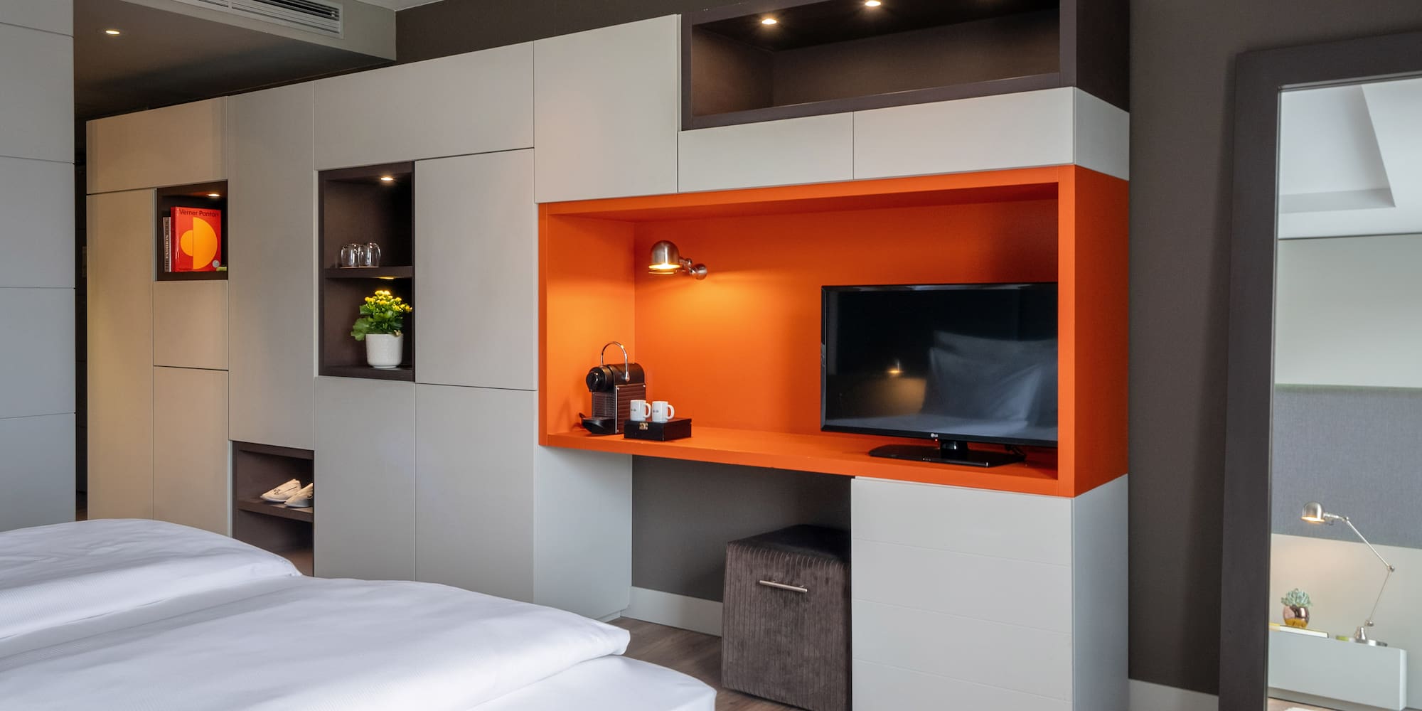 a room with a tv and shelves