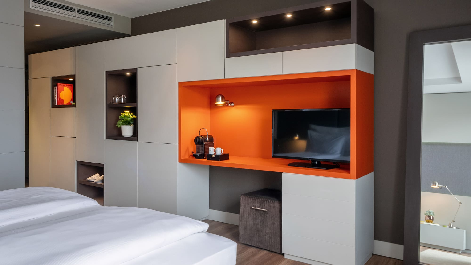 a room with a tv and shelves