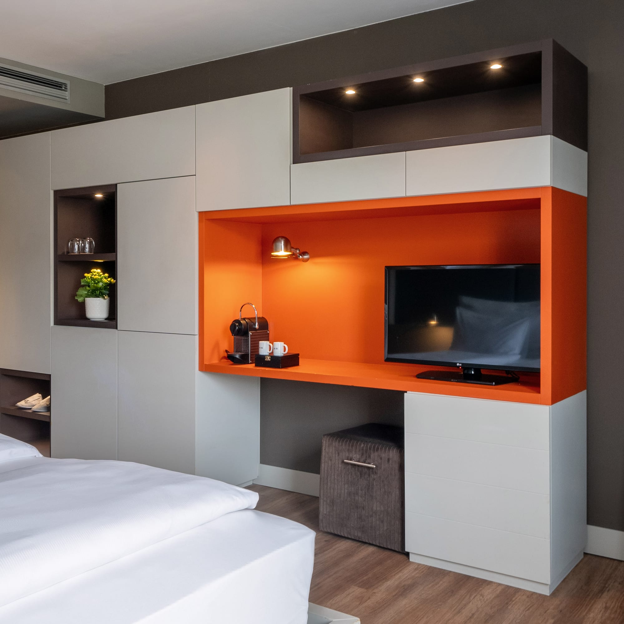 a room with a tv and shelves