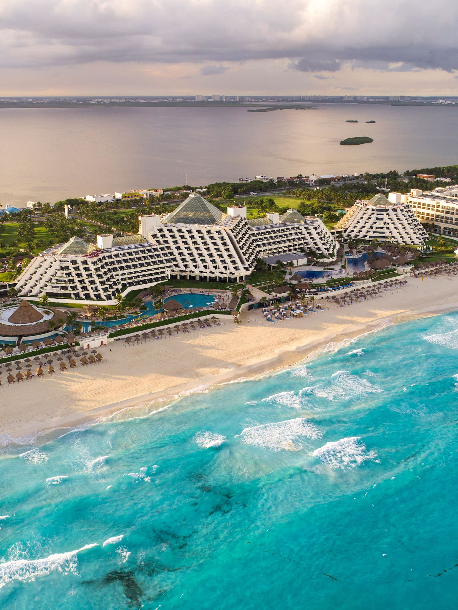 a beach with many buildings and a body of water