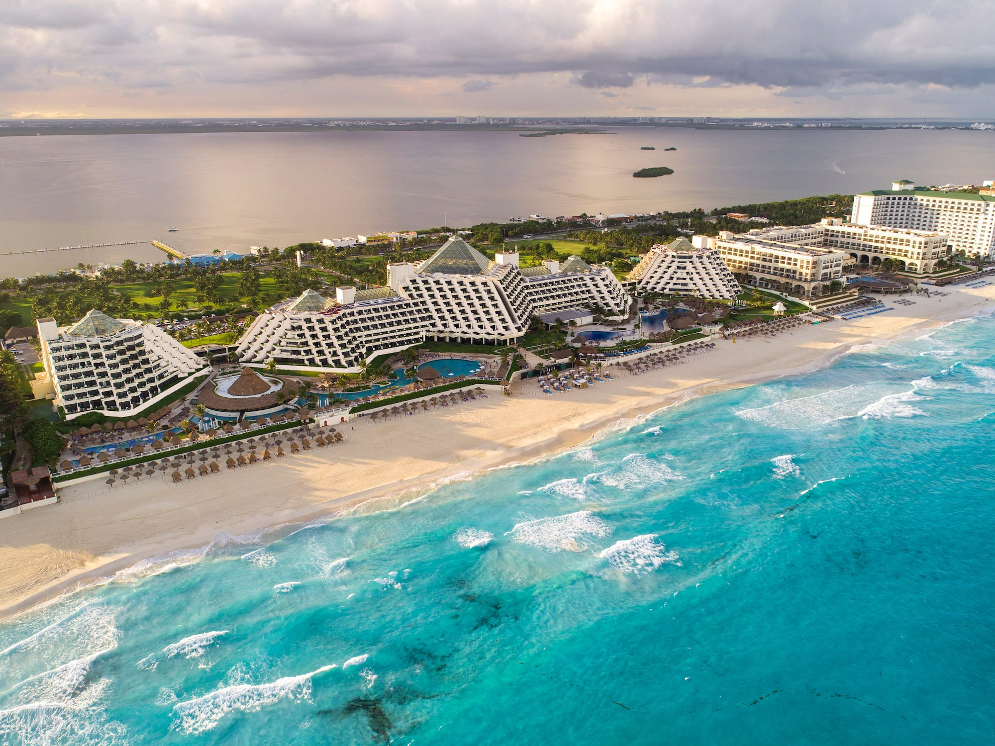 a beach with many buildings and a body of water