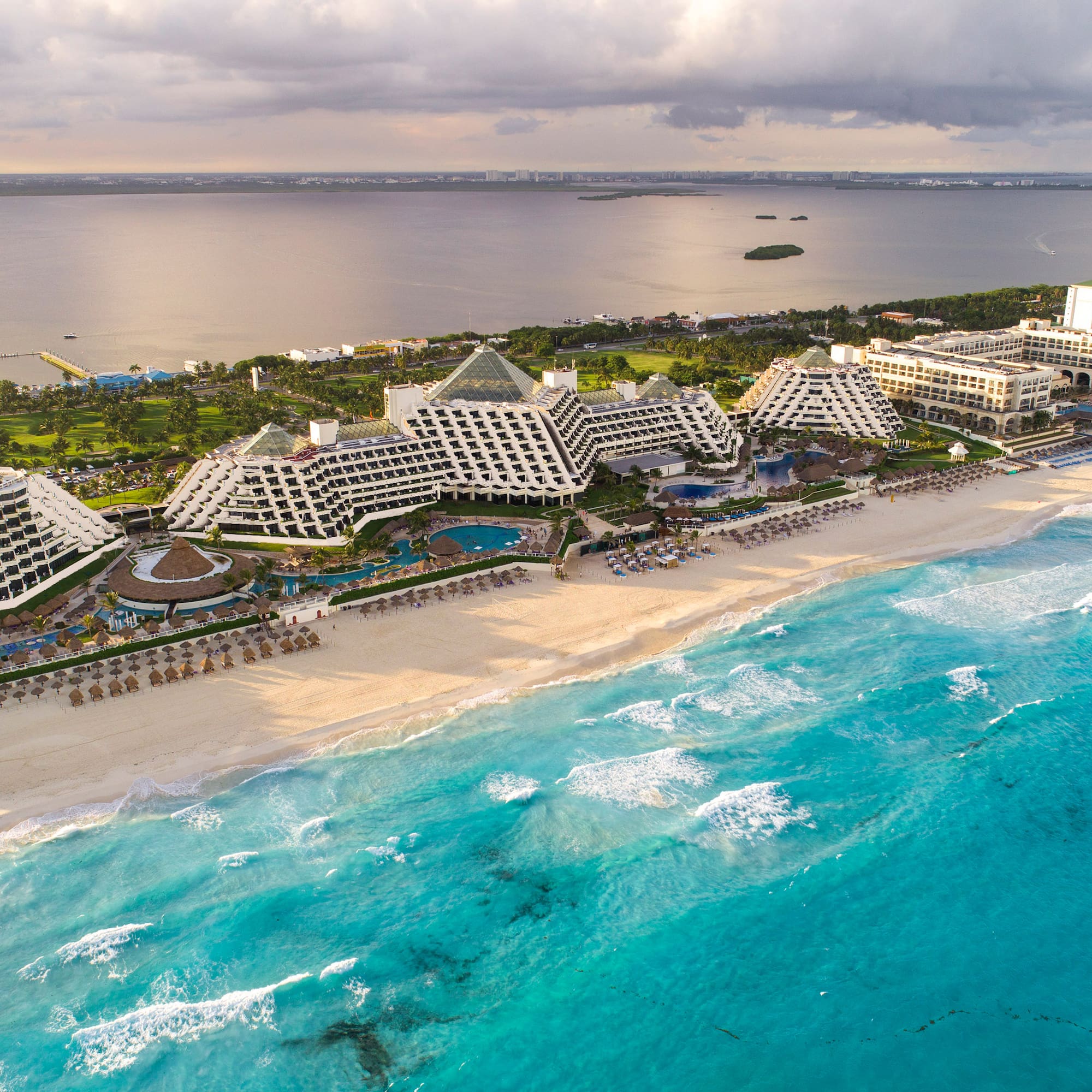 a beach with many buildings and a body of water