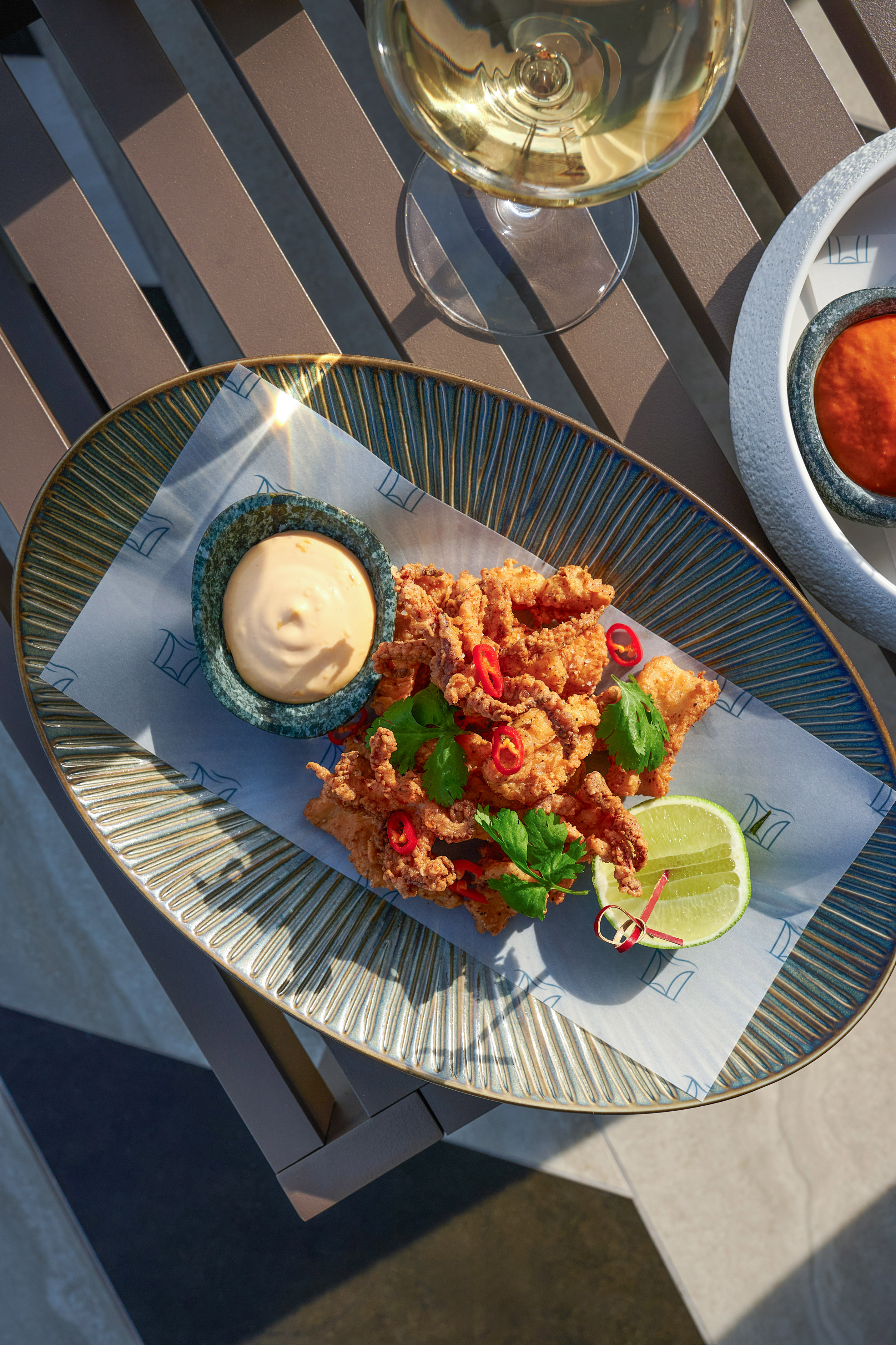 Crispy fried calamari with dipping sauce, lime, chili, and white wine.