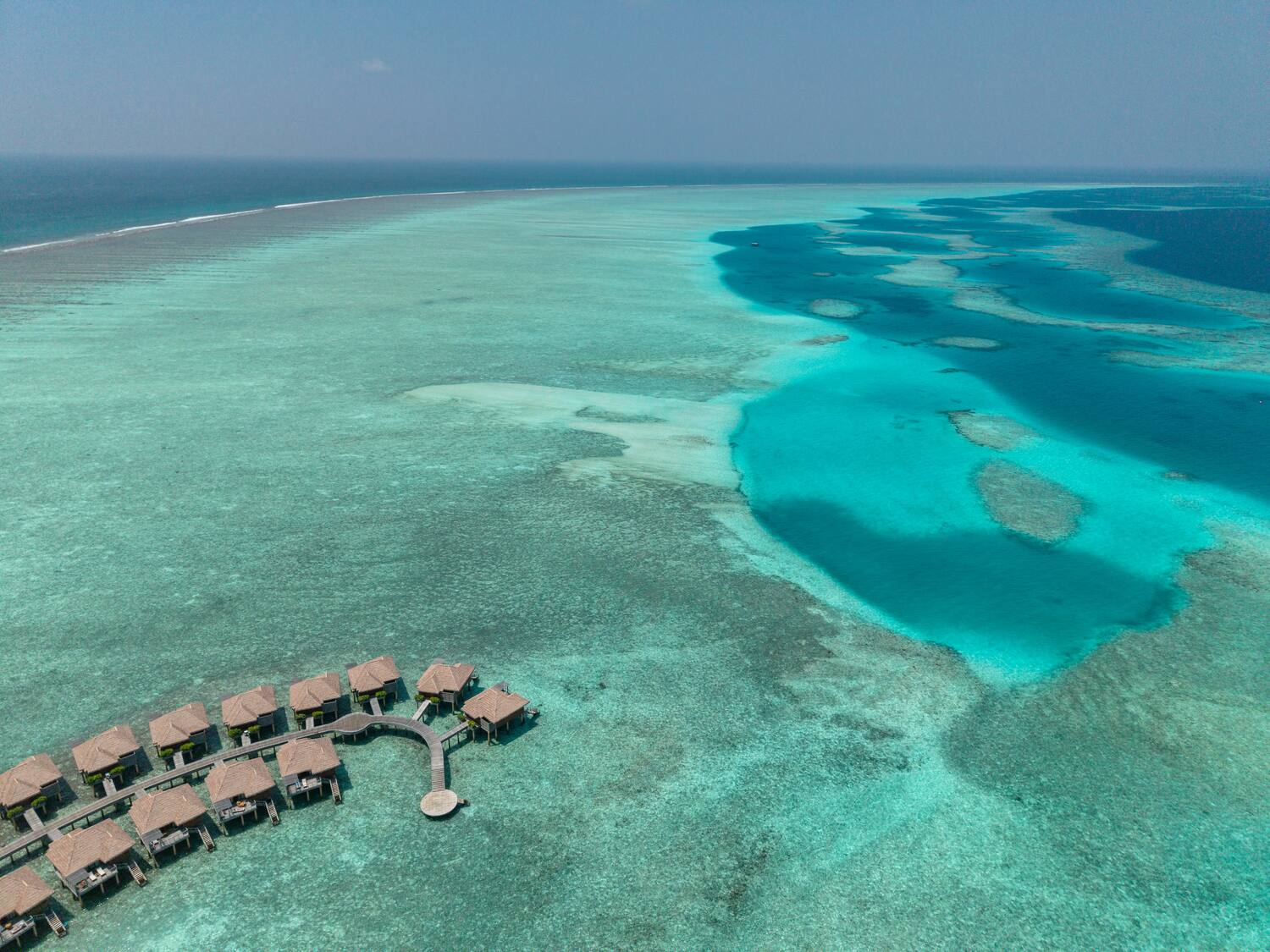 a group of huts on a beach