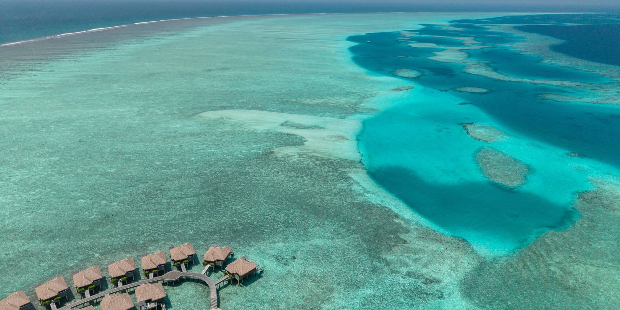 a group of huts on a beach