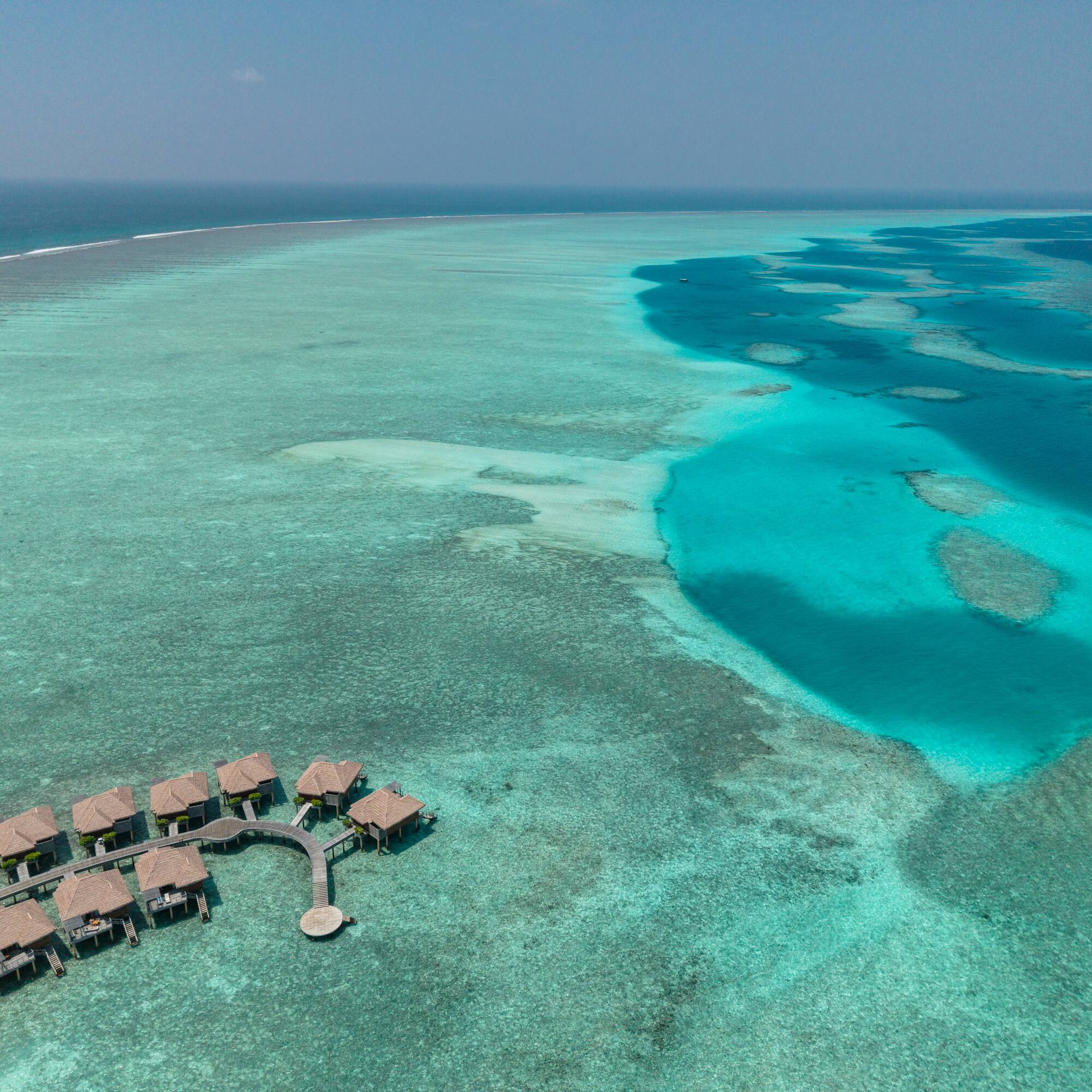 a group of huts on a beach
