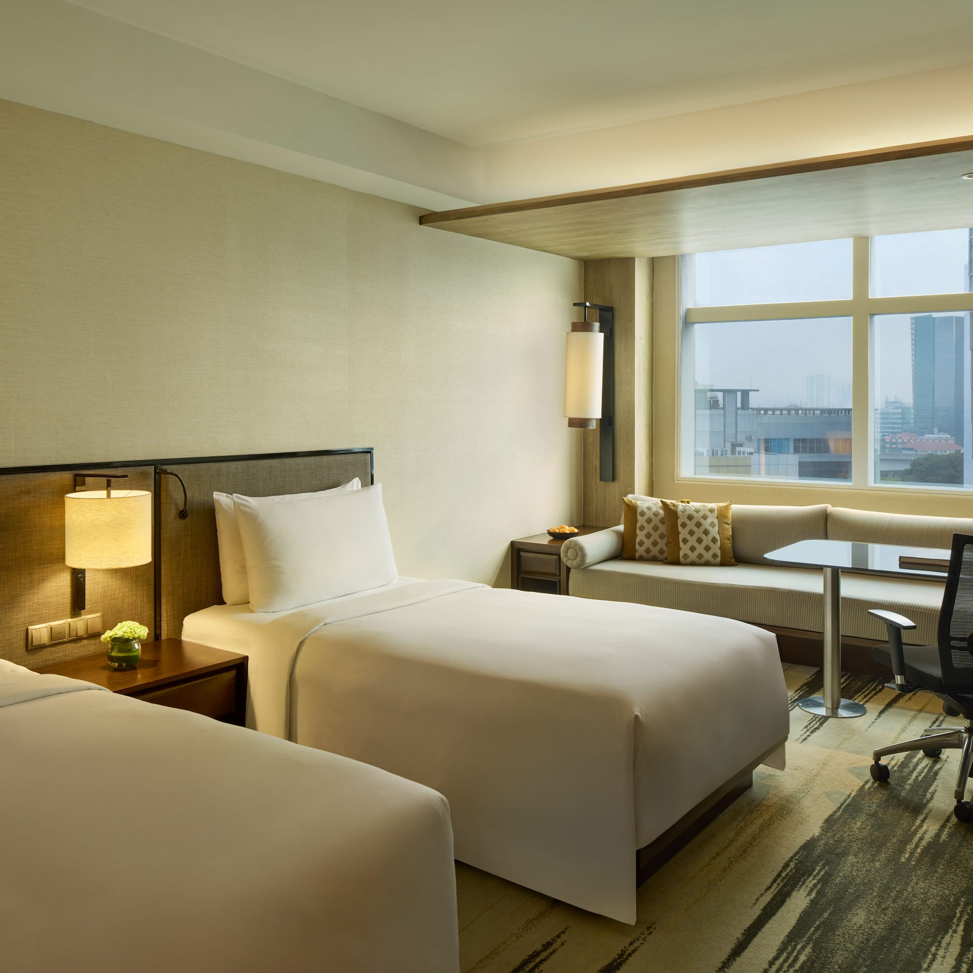 a hotel room with two beds and a desk