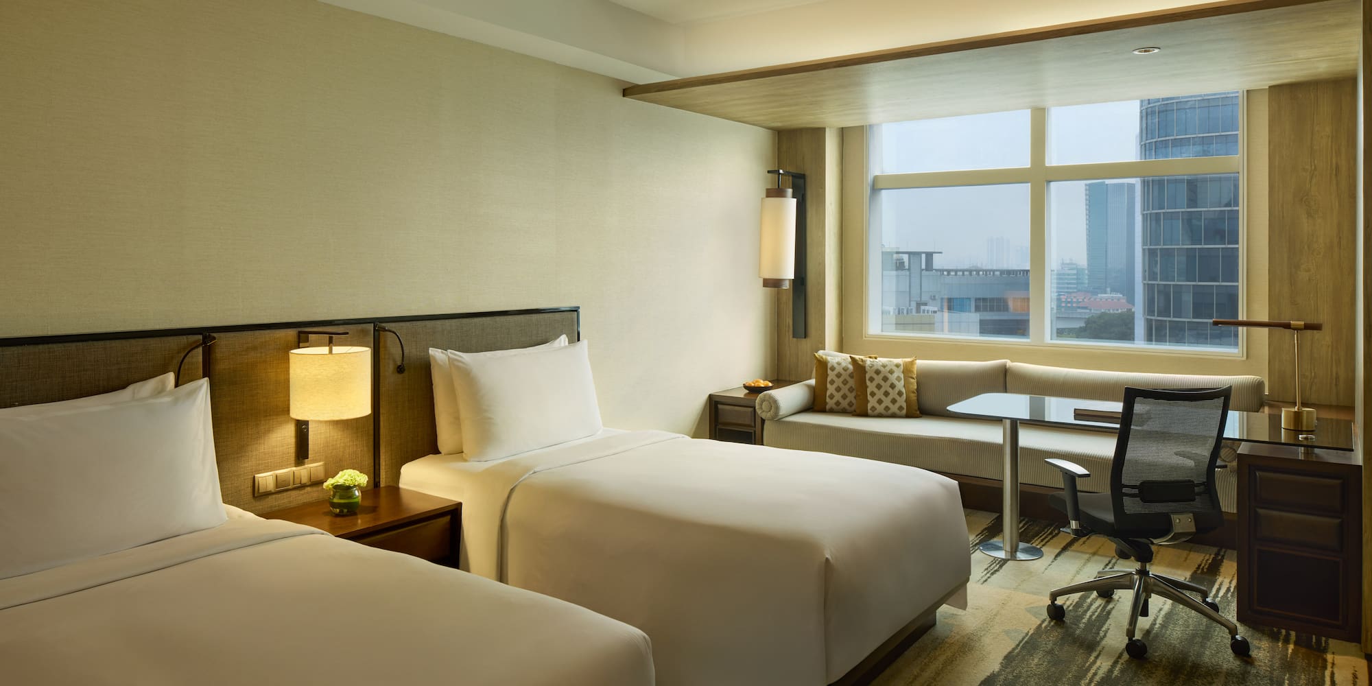 a hotel room with two beds and a desk