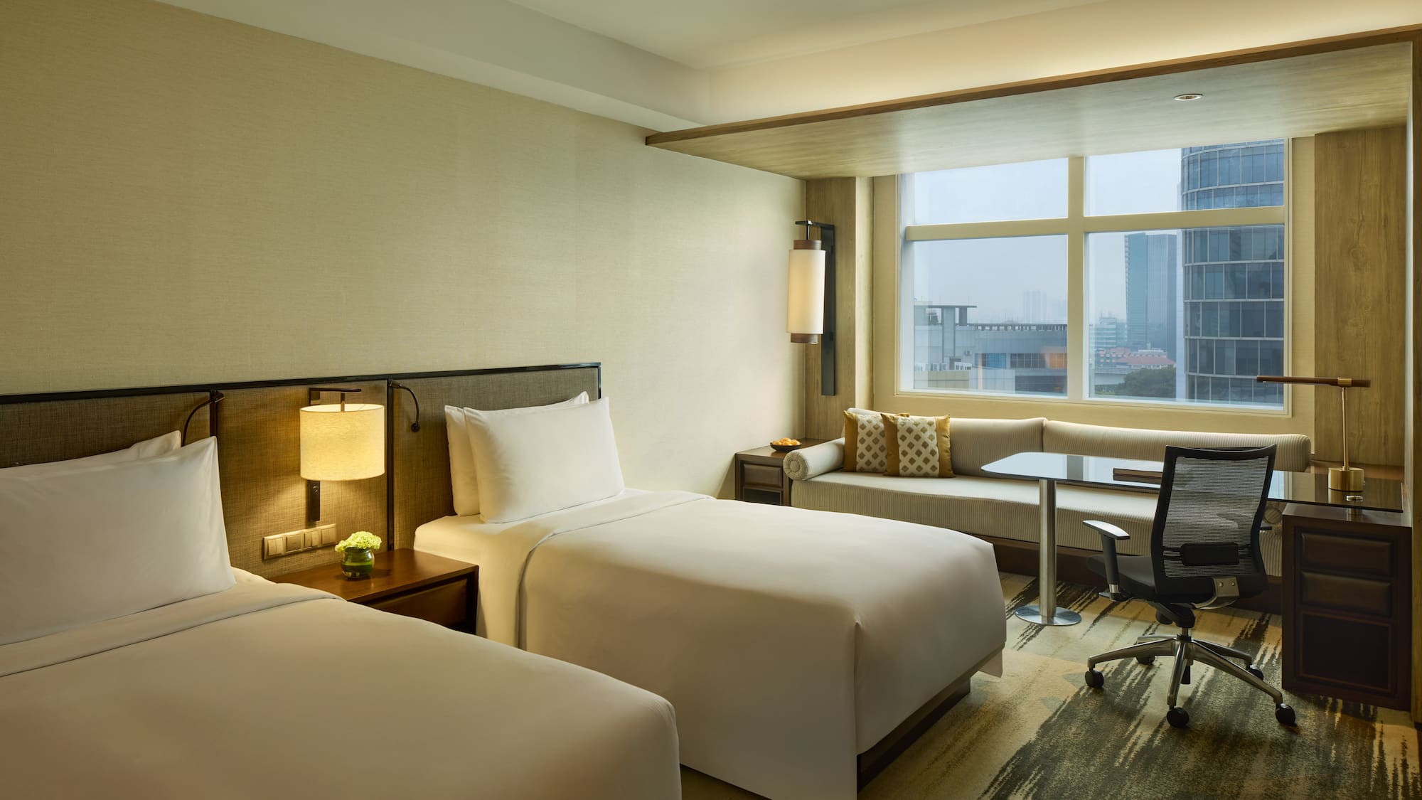 a hotel room with two beds and a desk