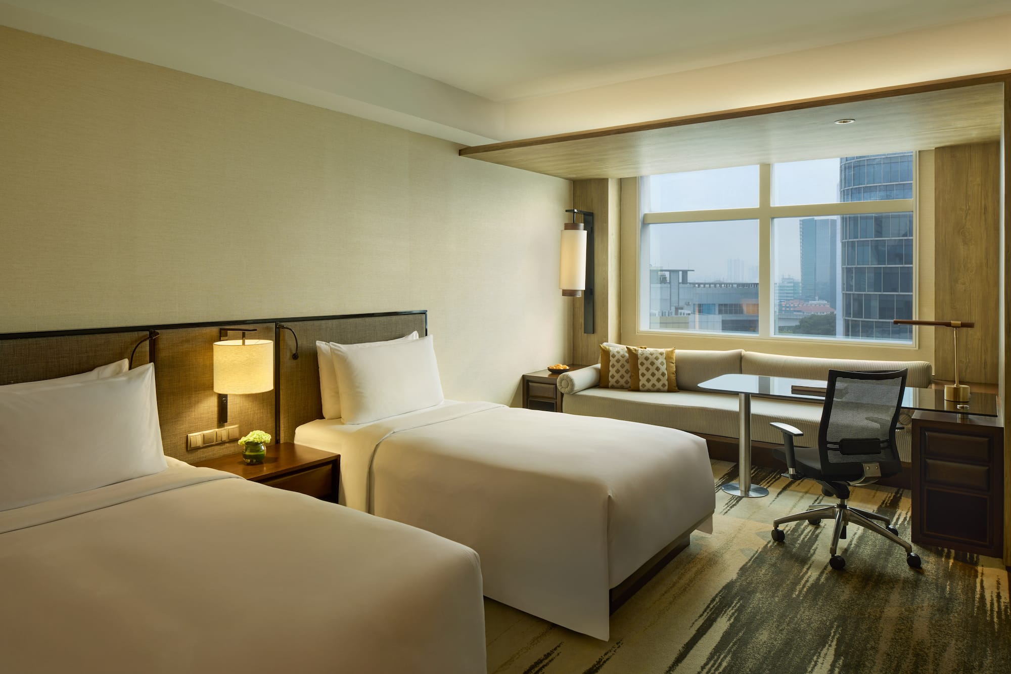 a hotel room with two beds and a desk