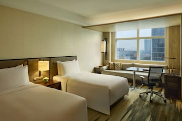 a hotel room with two beds and a desk