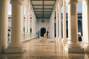 a man doing yoga in a hallway