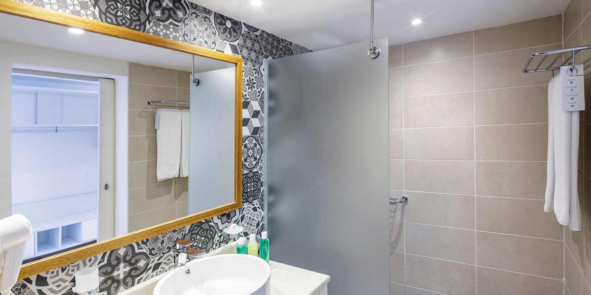 a bathroom with a mirror and sink