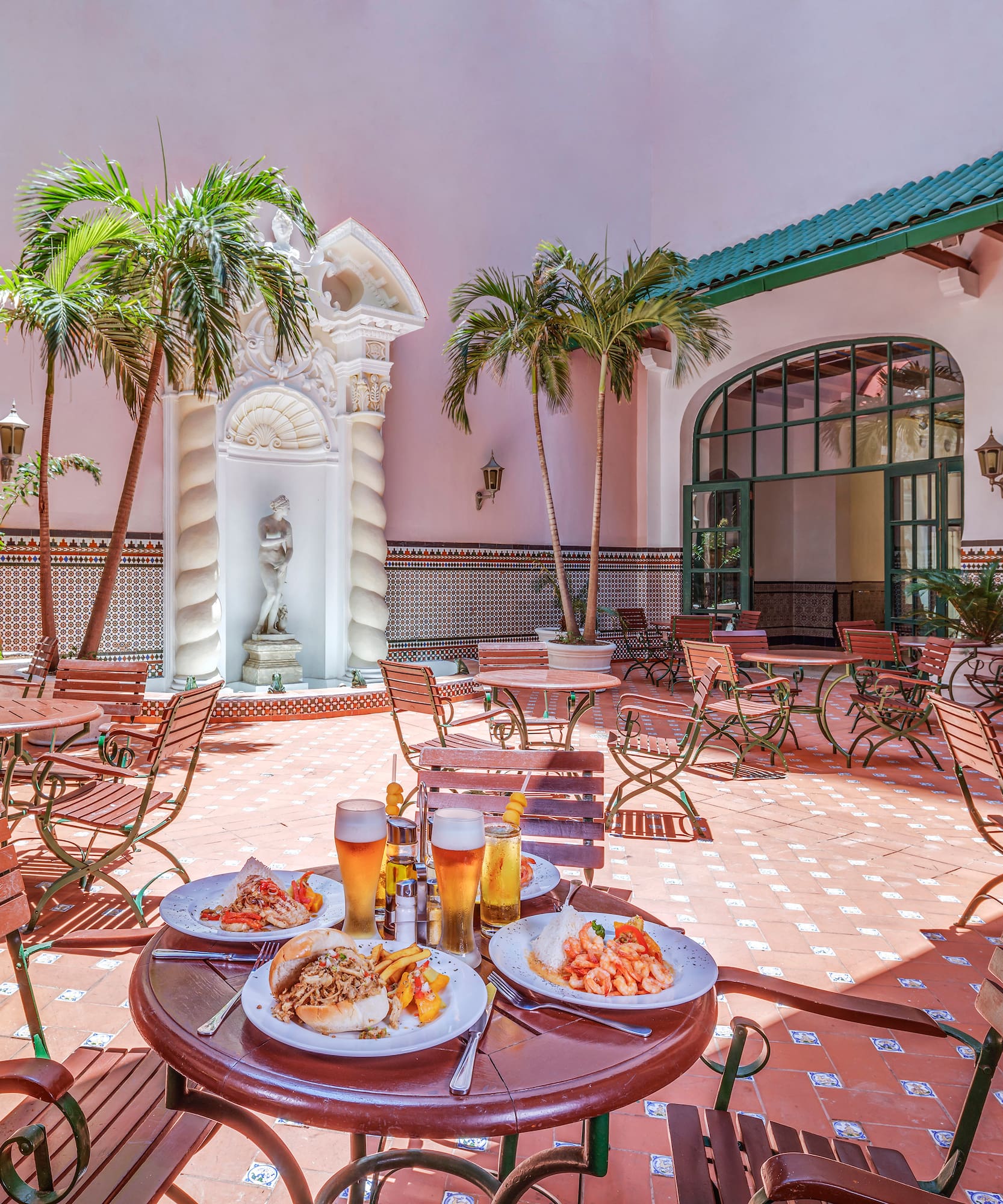 a patio with tables and chairs and food on it