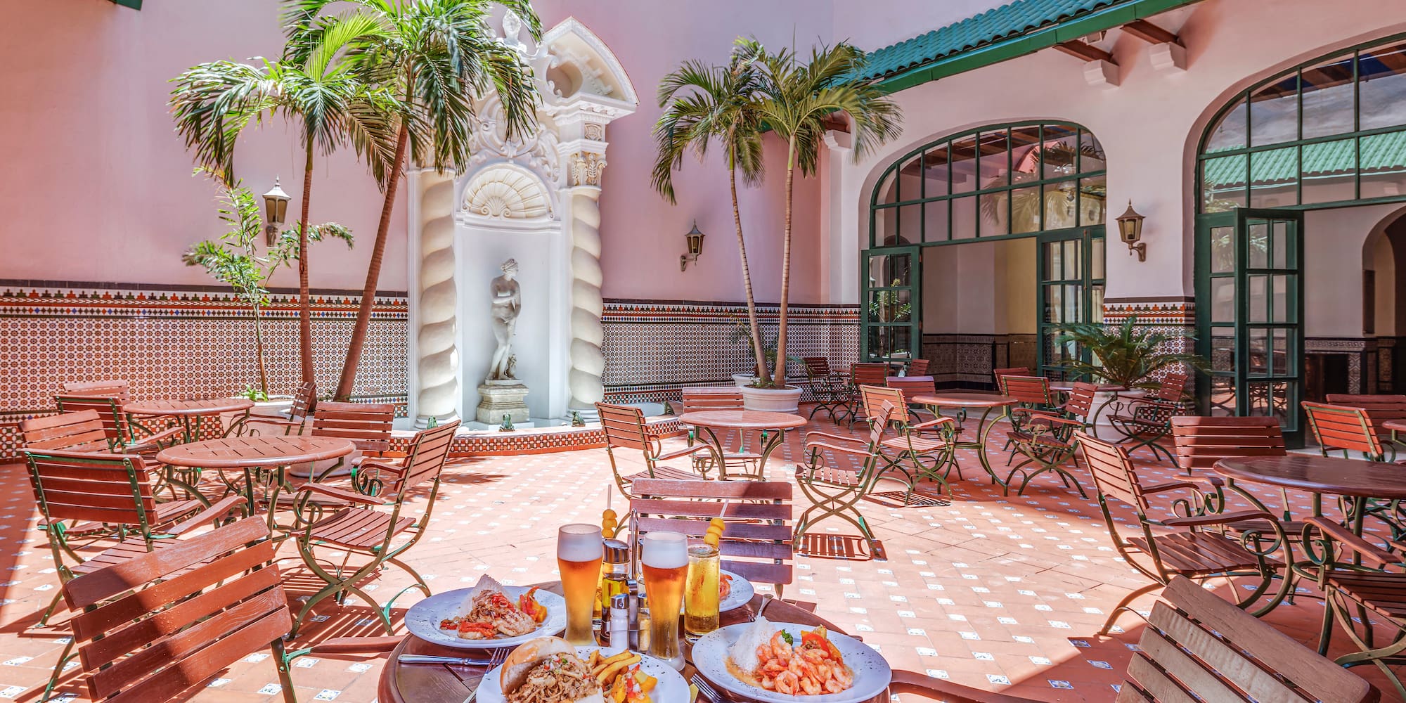 a patio with tables and chairs and food on it