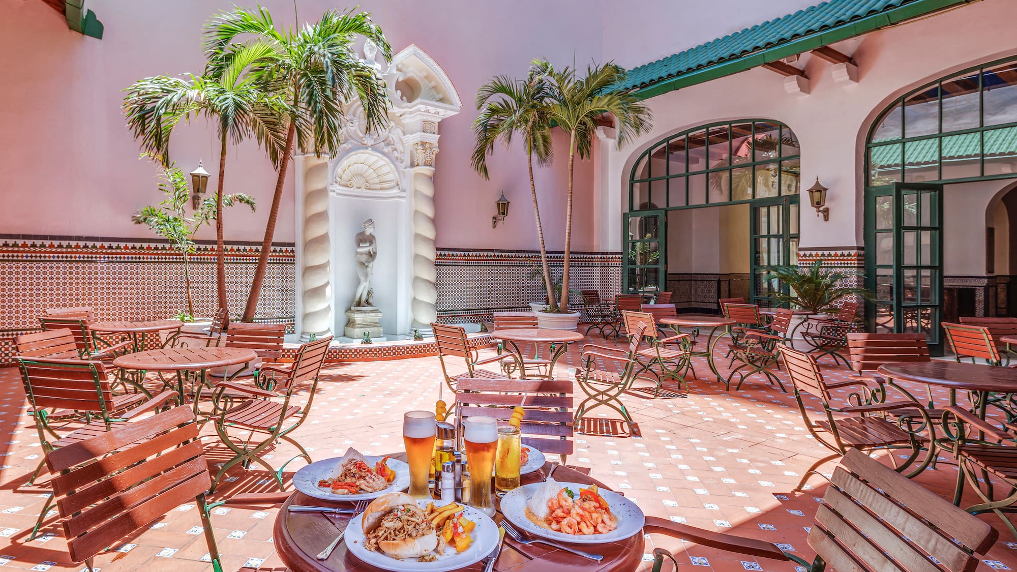 a patio with tables and chairs and food on it