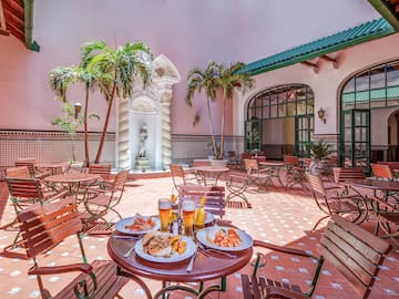 a patio with tables and chairs and food on it