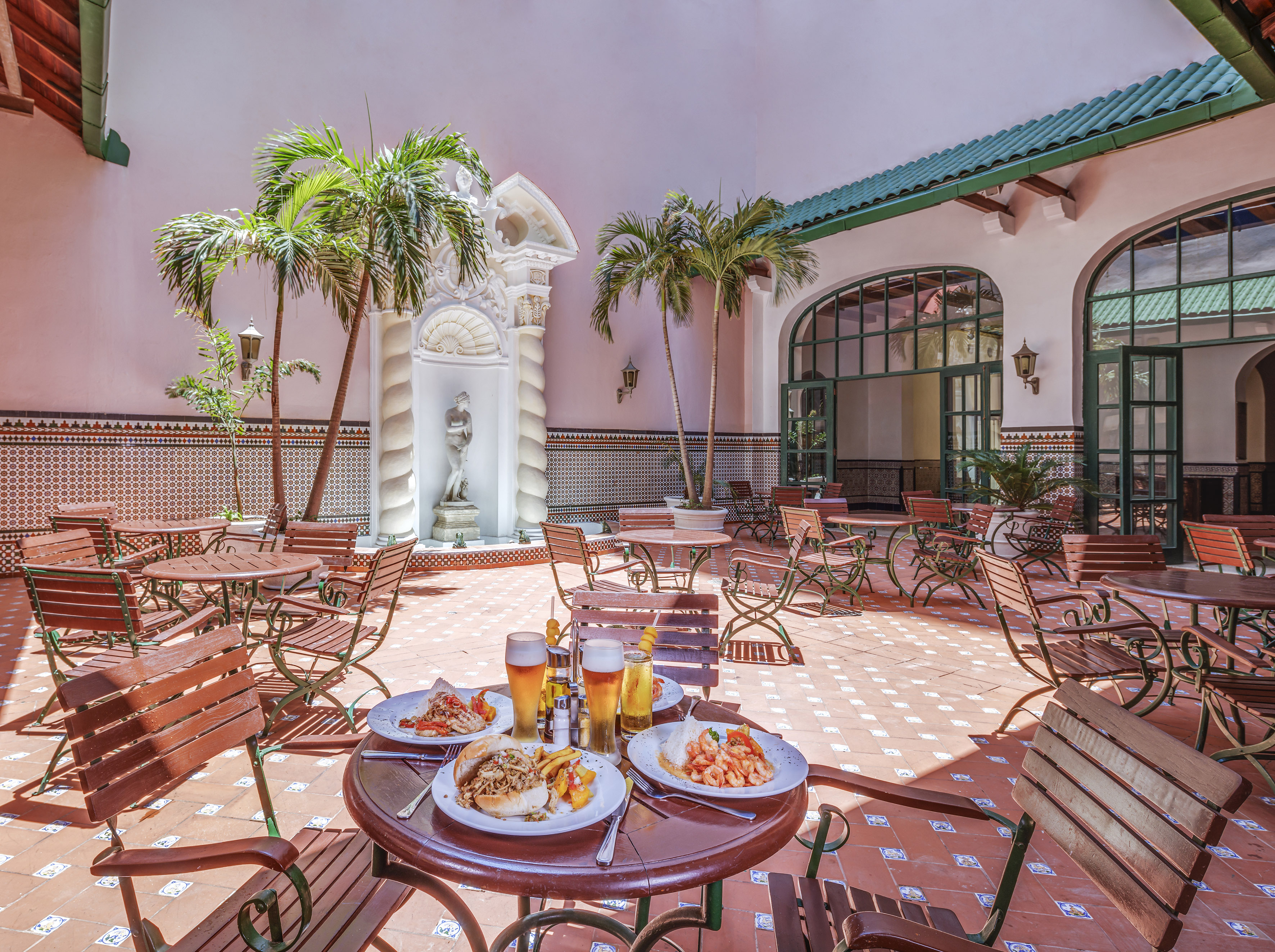 a patio with tables and chairs and food on it