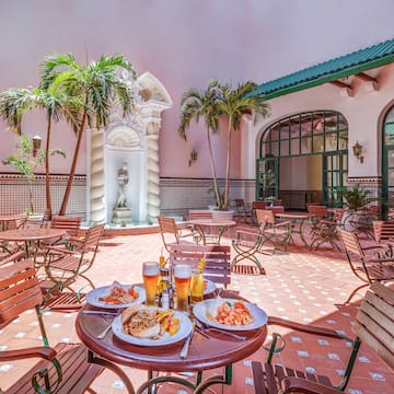a patio with tables and chairs and food on it