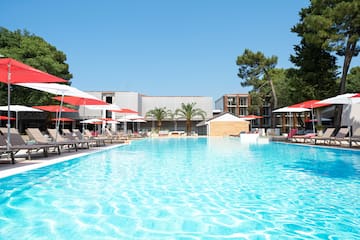 a pool with umbrellas and chairs
