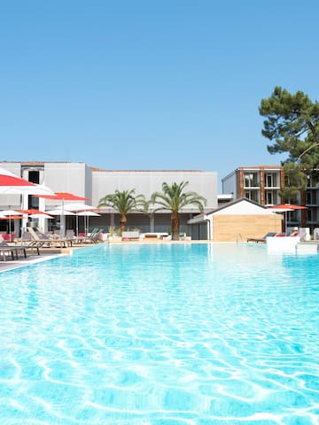 a pool with umbrellas and chairs