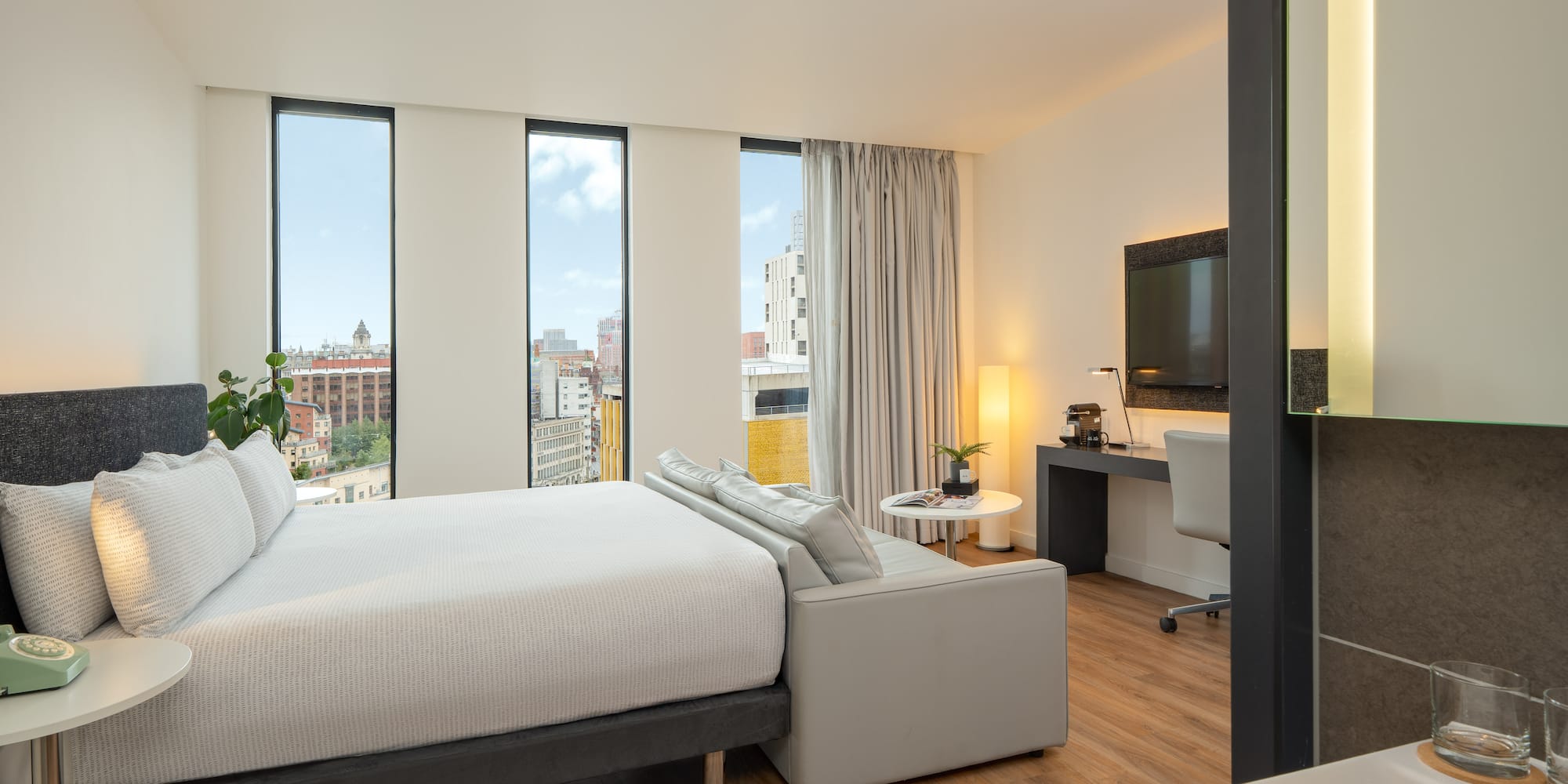 a bedroom with a large bed and a television