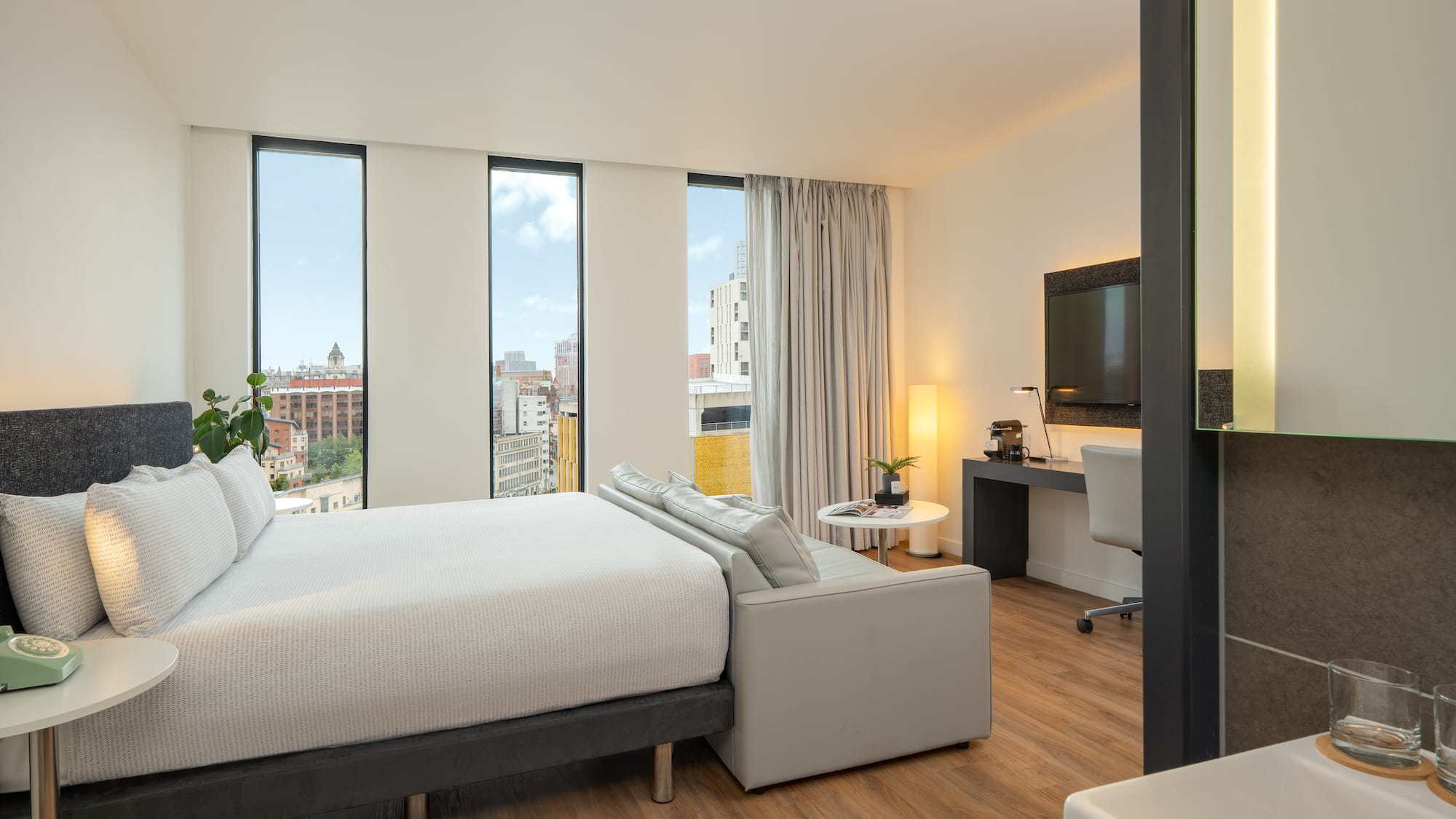 a bedroom with a large bed and a television