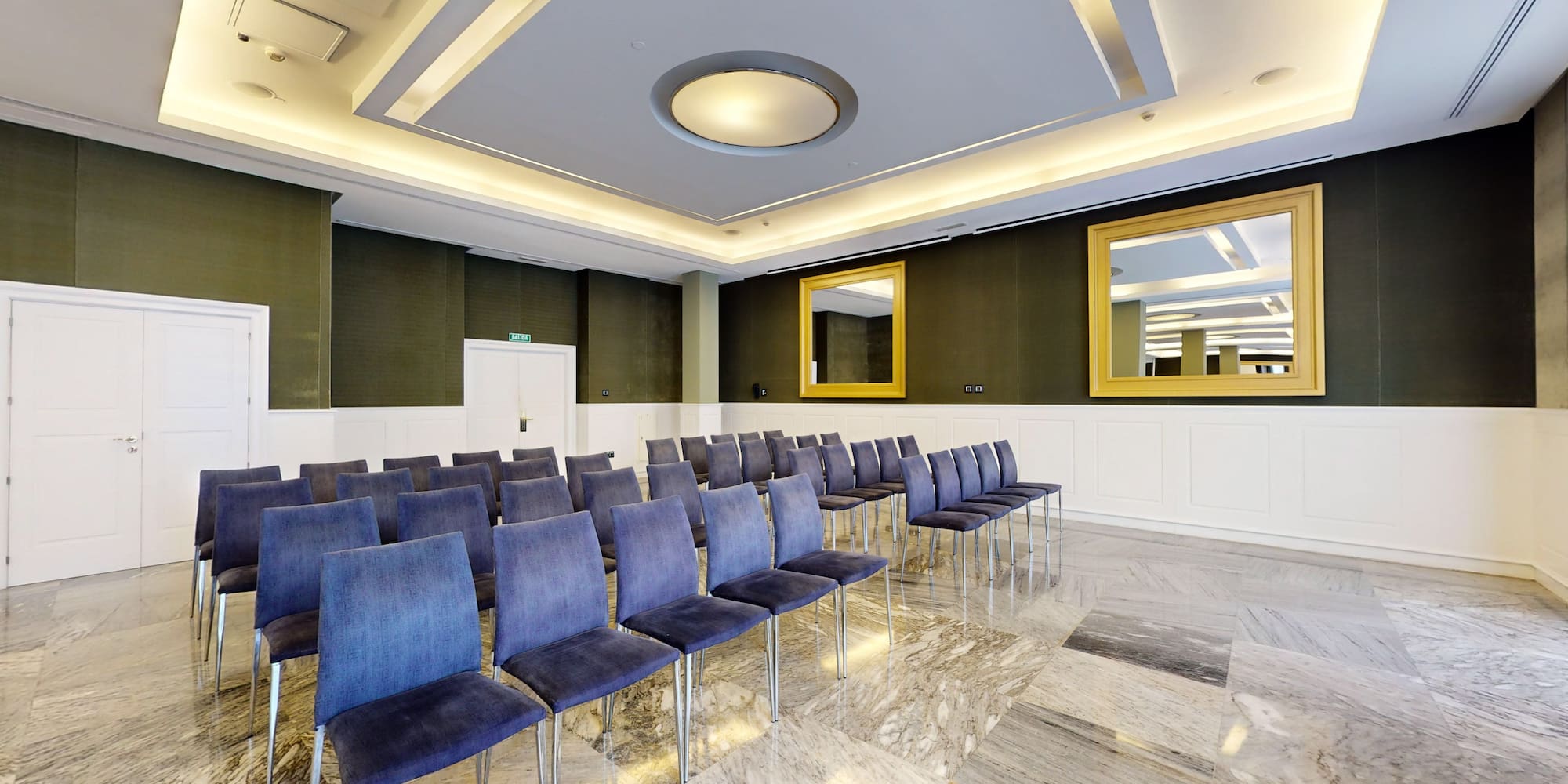 a room with chairs and mirrors