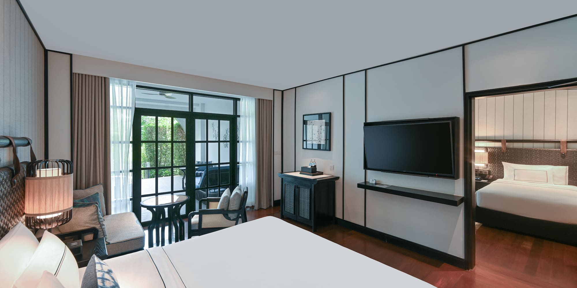 a room with a bed and a television