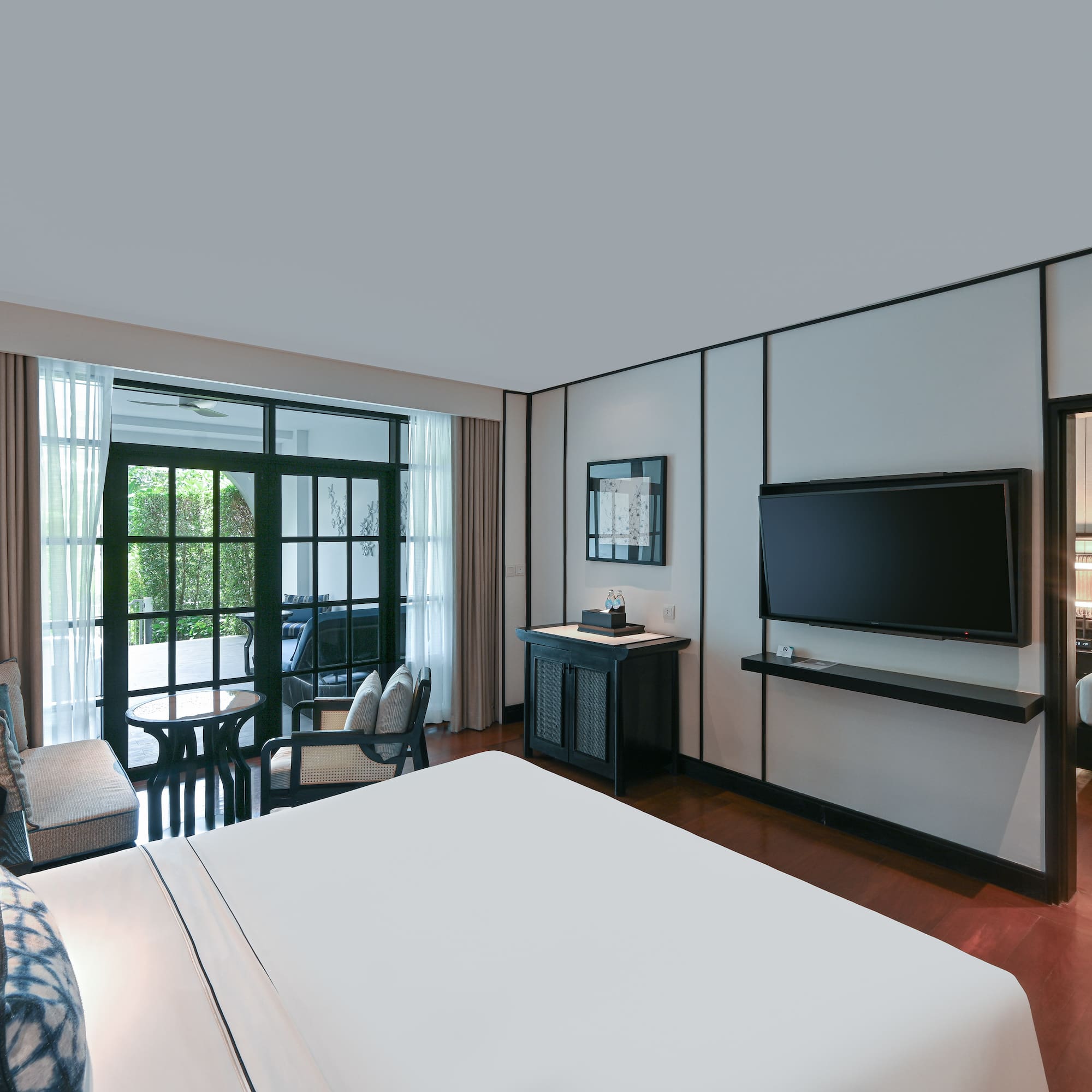 a room with a bed and a television