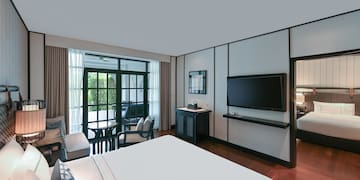 a room with a bed and a television