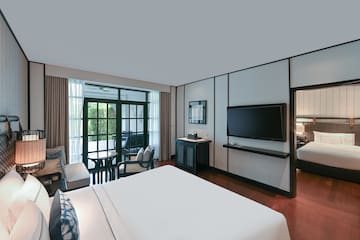 a room with a bed and a television