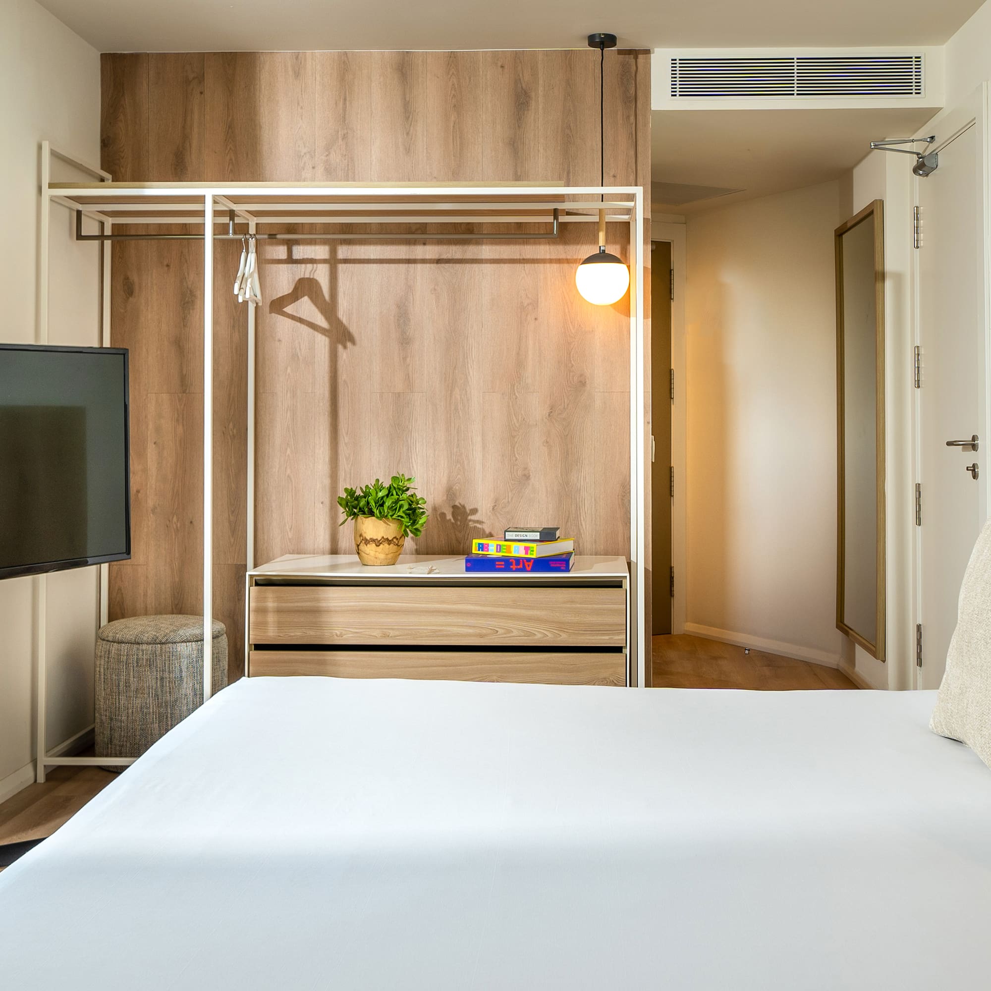 a room with a bed and a tv